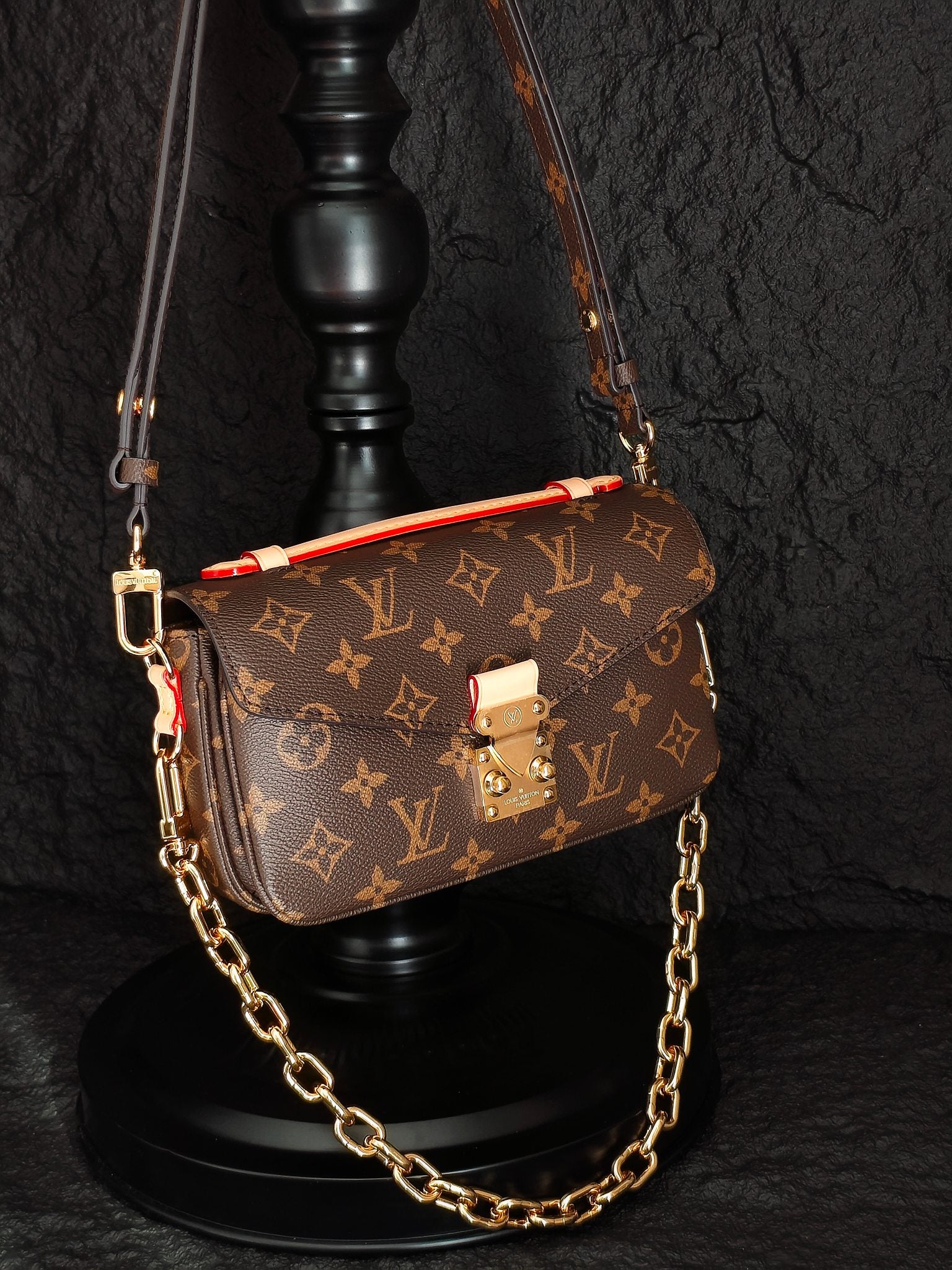 Brown monogram crossbody bag with flap, gold-tone clasp, and chain shoulder strap