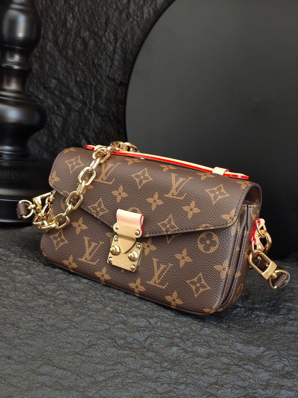 Brown monogram crossbody bag with chain strap and front flap closure