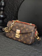 Brown monogram crossbody bag with chain strap and front flap closure