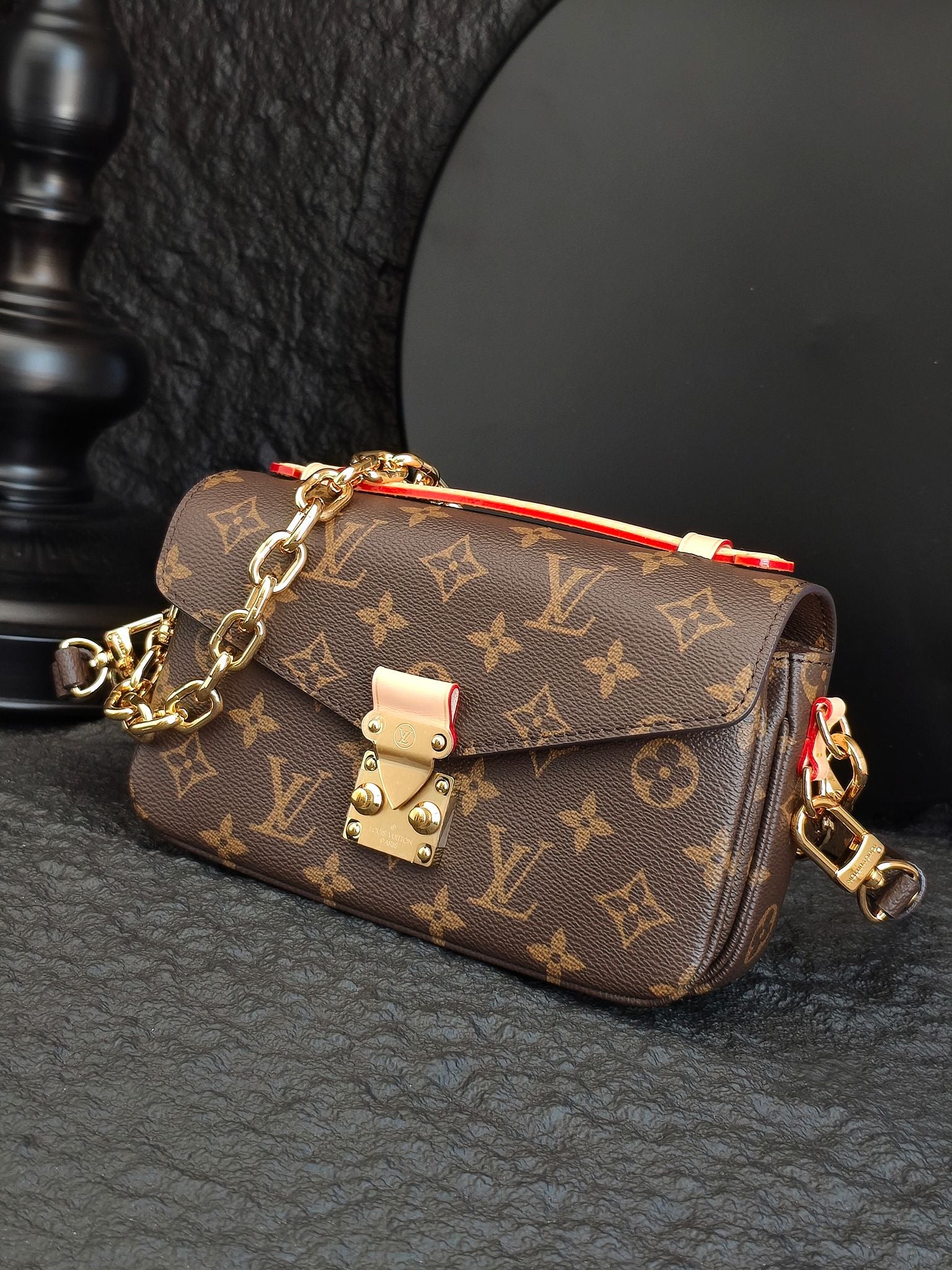 Brown monogram crossbody bag with chain strap and front flap closure