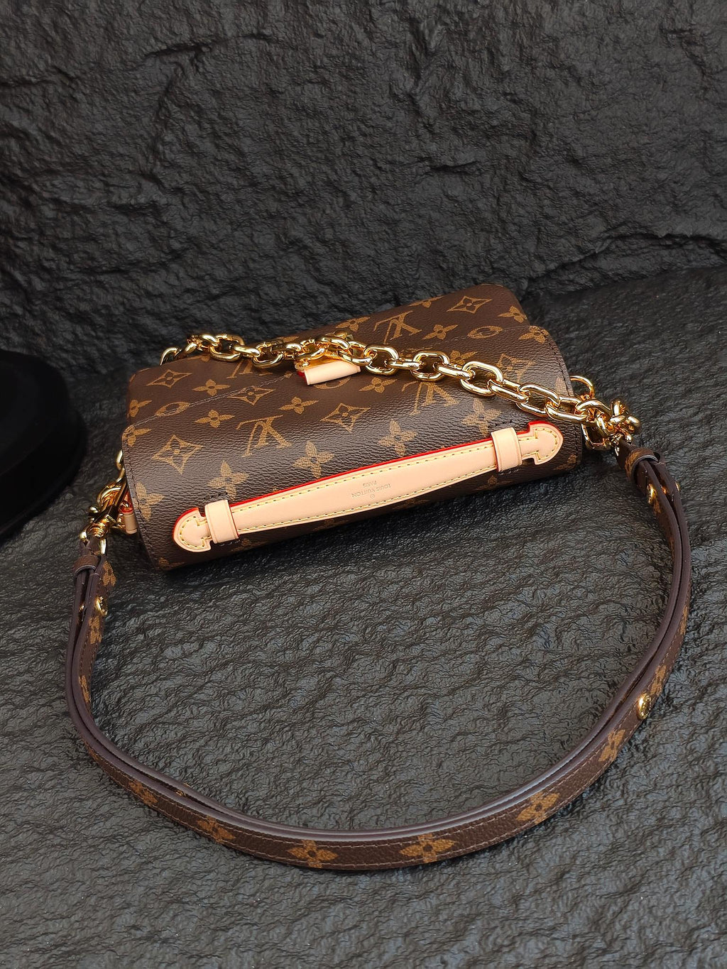 Brown monogram crossbody bag with long strap and decorative light-colored strap trim