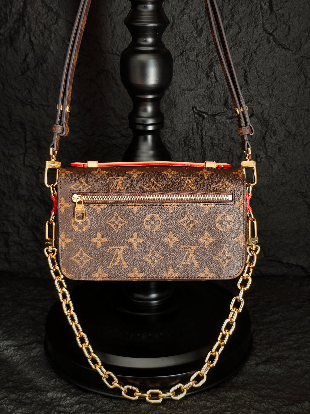 Brown monogram crossbody bag with top flap, decorative trim, and gold-tone chain strap