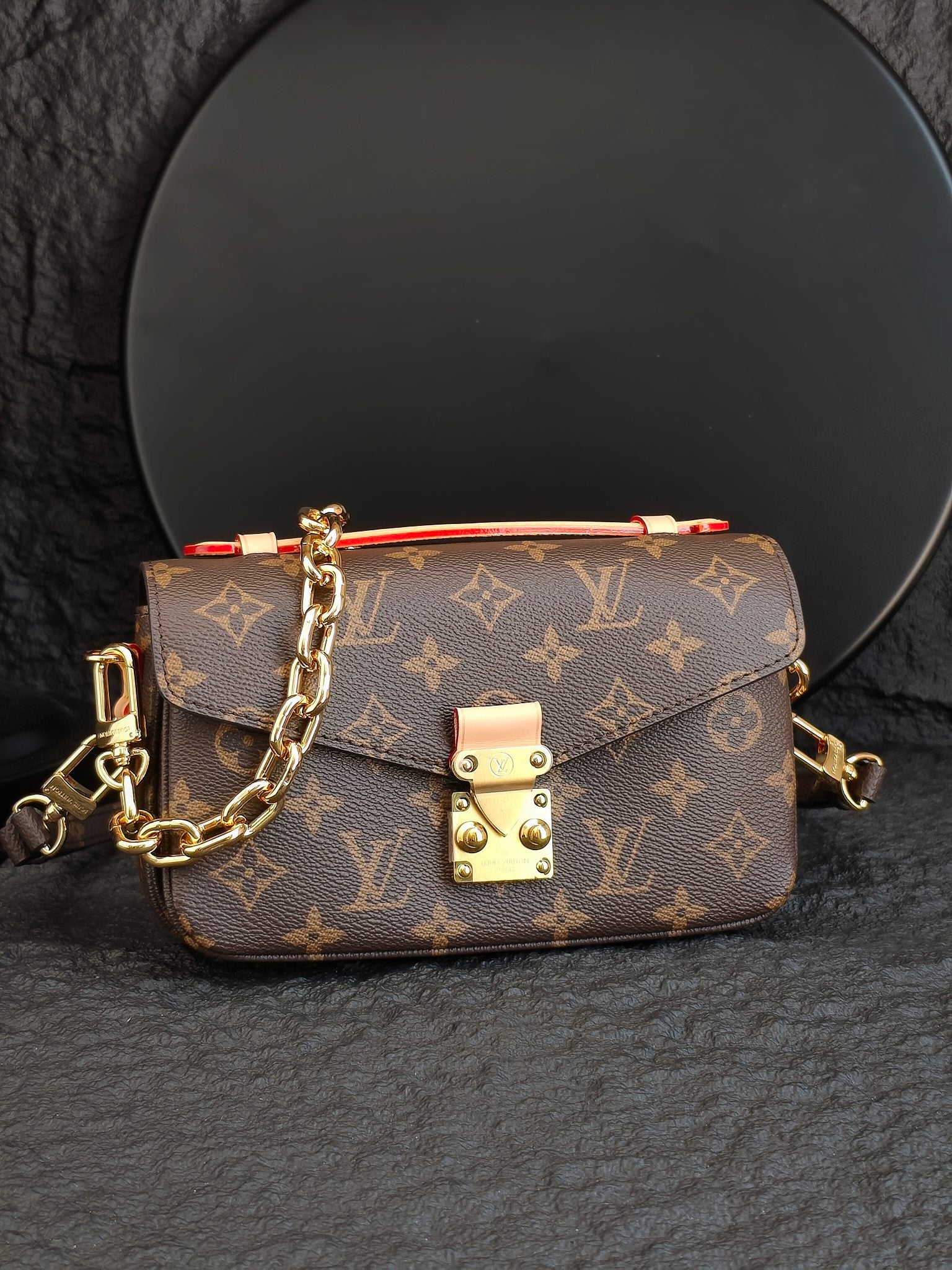 Brown monogram crossbody bag with front flap and gold-tone clasp detail