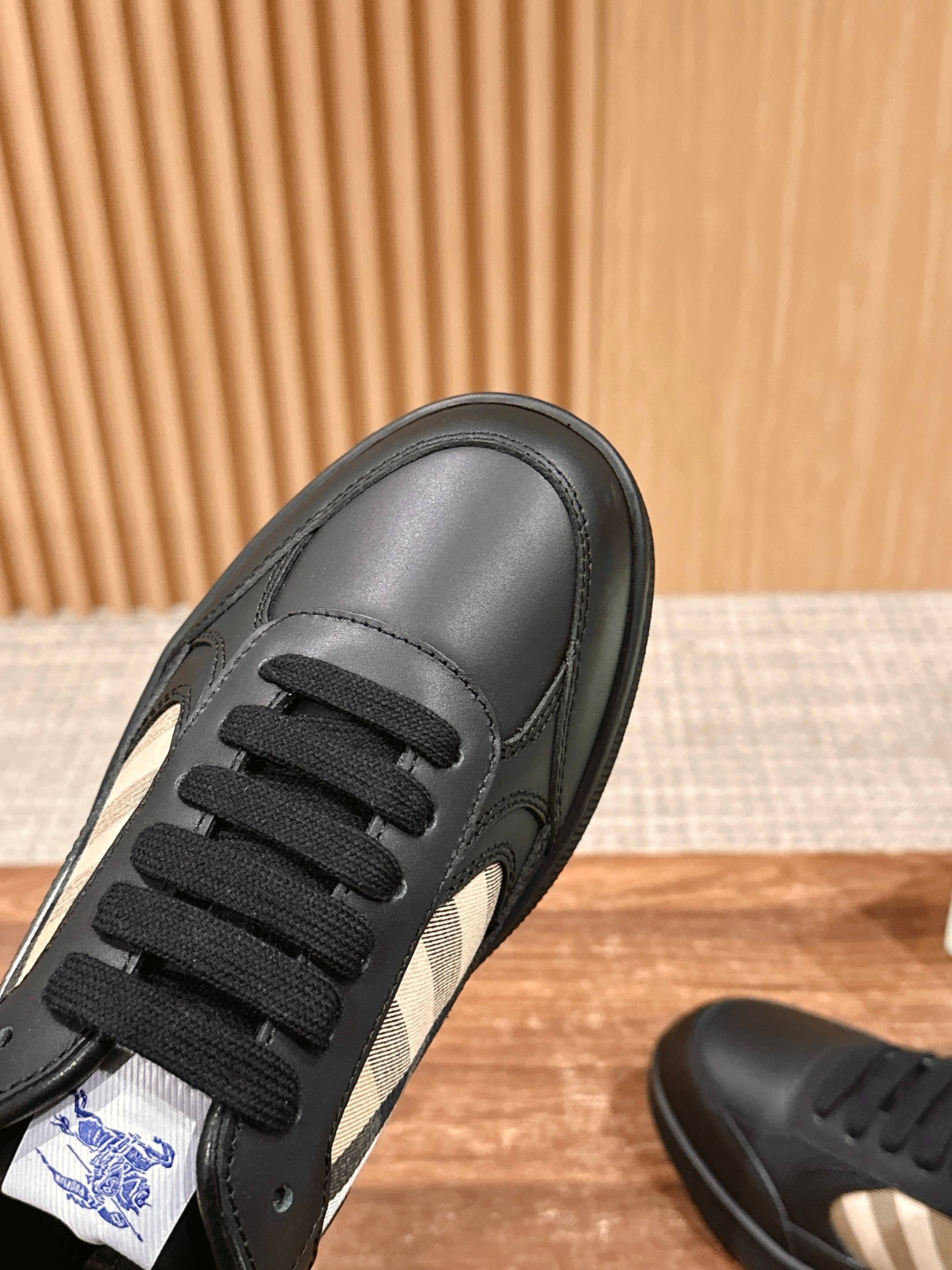 Burberry black leather sneaker side view with lace-up detail and stitch lines