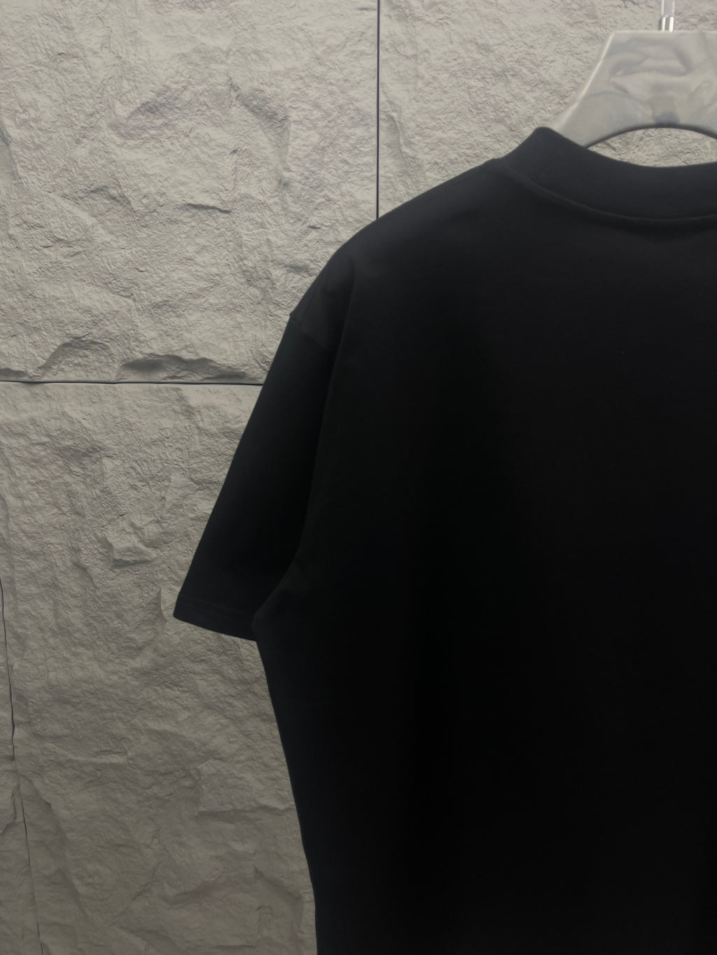 Black crewneck T-shirt back view from the side