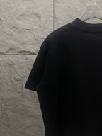 Black crewneck T-shirt back view from the side
