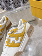 Fendi white leather sneakers with yellow logo overlay and tan sole