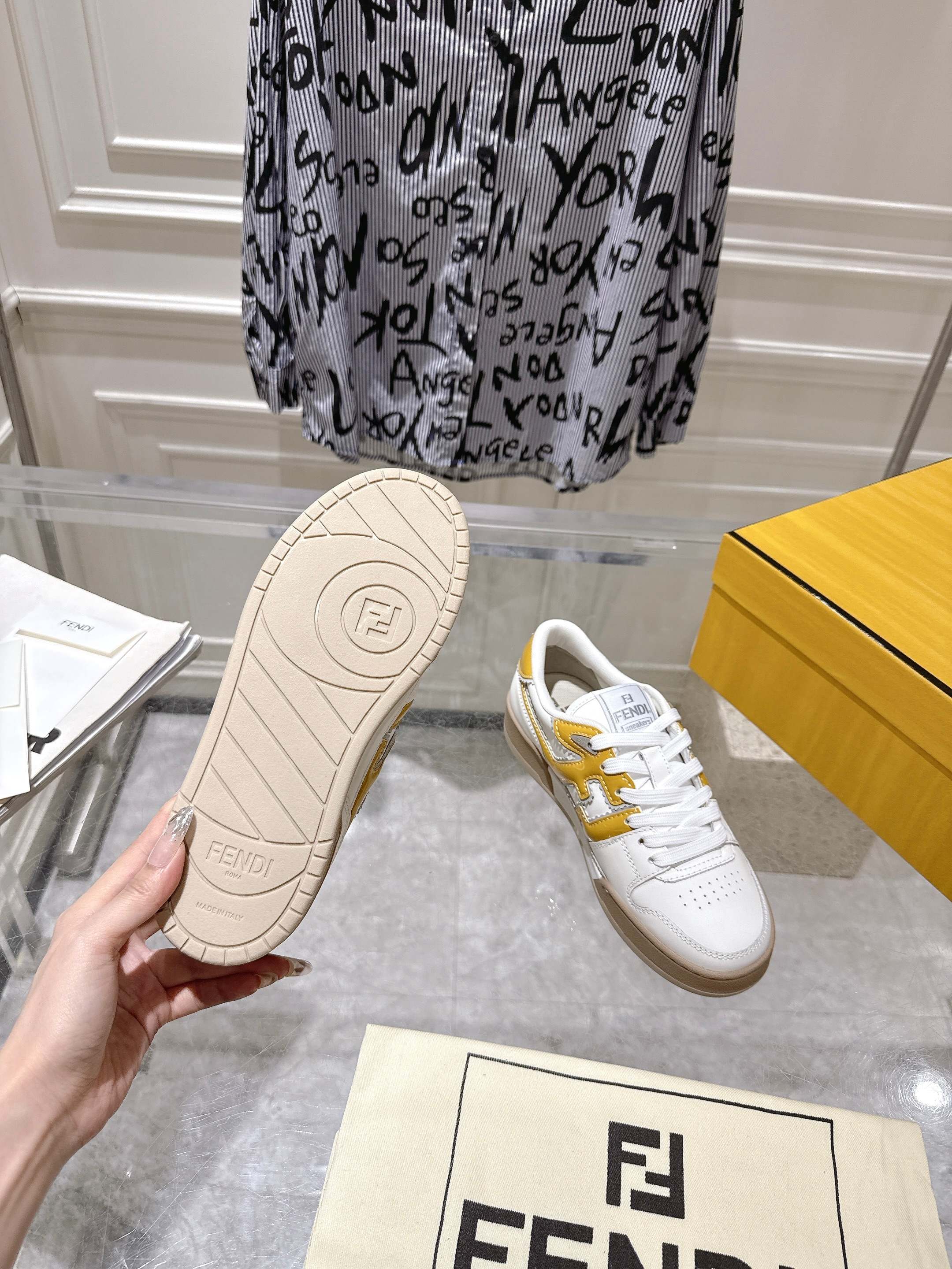 Fendi sneakers outsole with white upper and yellow heel accent