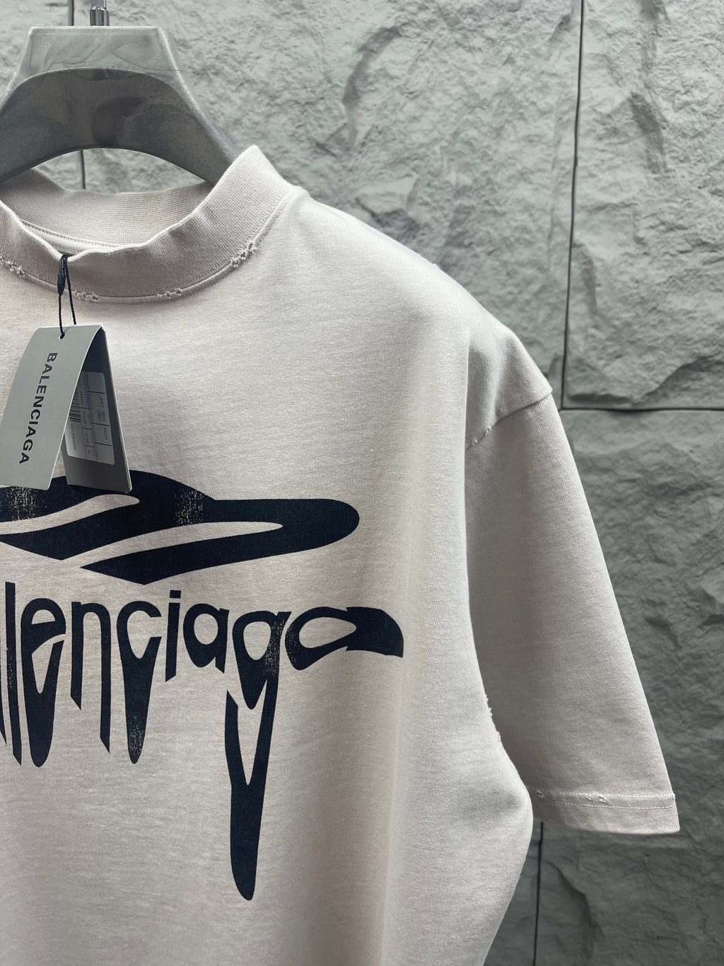 White Balenciaga T-shirt close-up with large front logo graphic