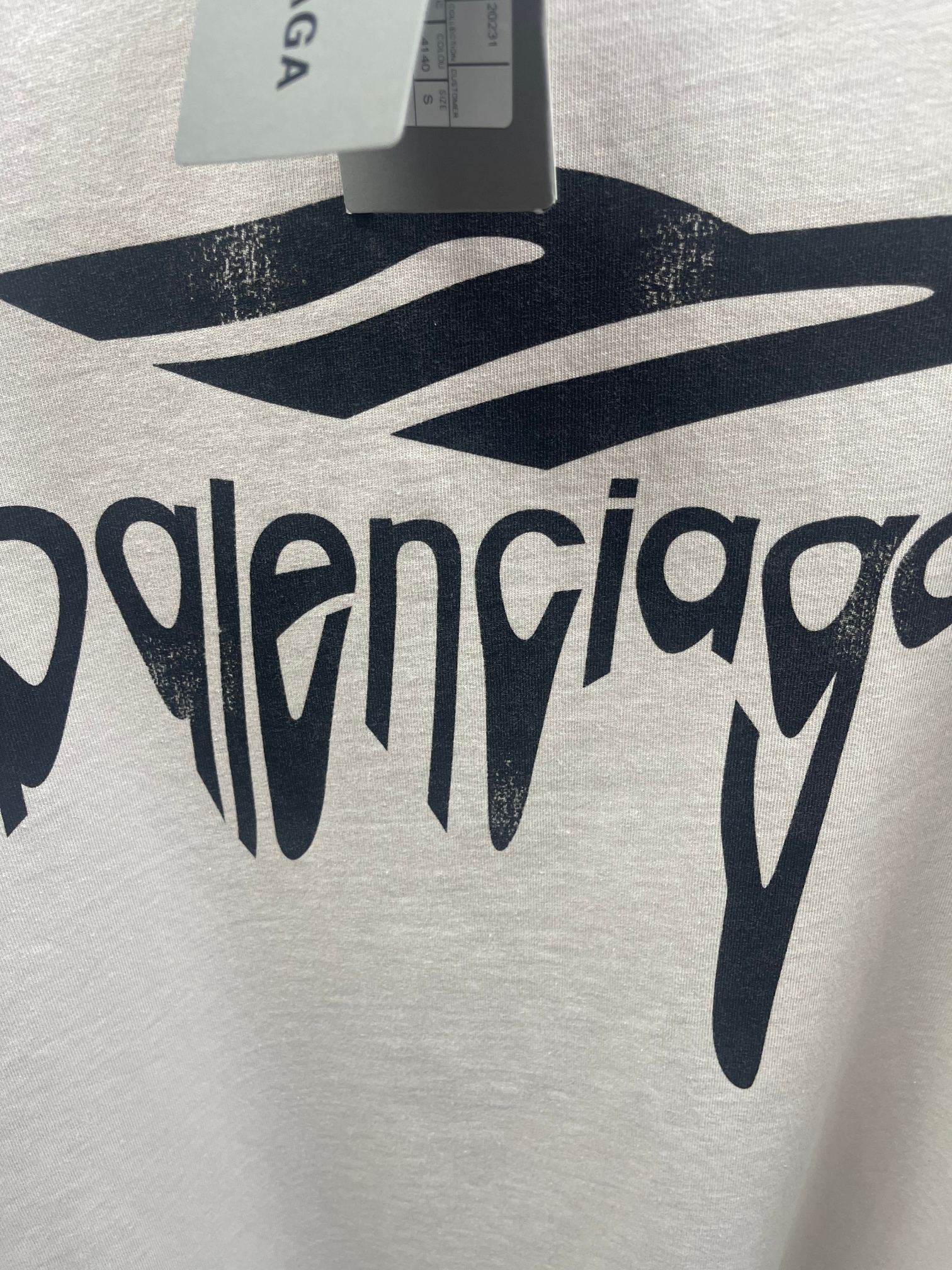 White Balenciaga T-shirt fabric close-up with large logo lettering