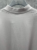 White Balenciaga T-shirt neckline detail with small studs along collar