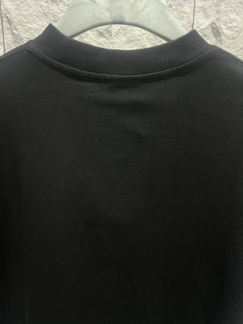 Black short-sleeve T-shirt with ribbed crew neck, no visible logo
