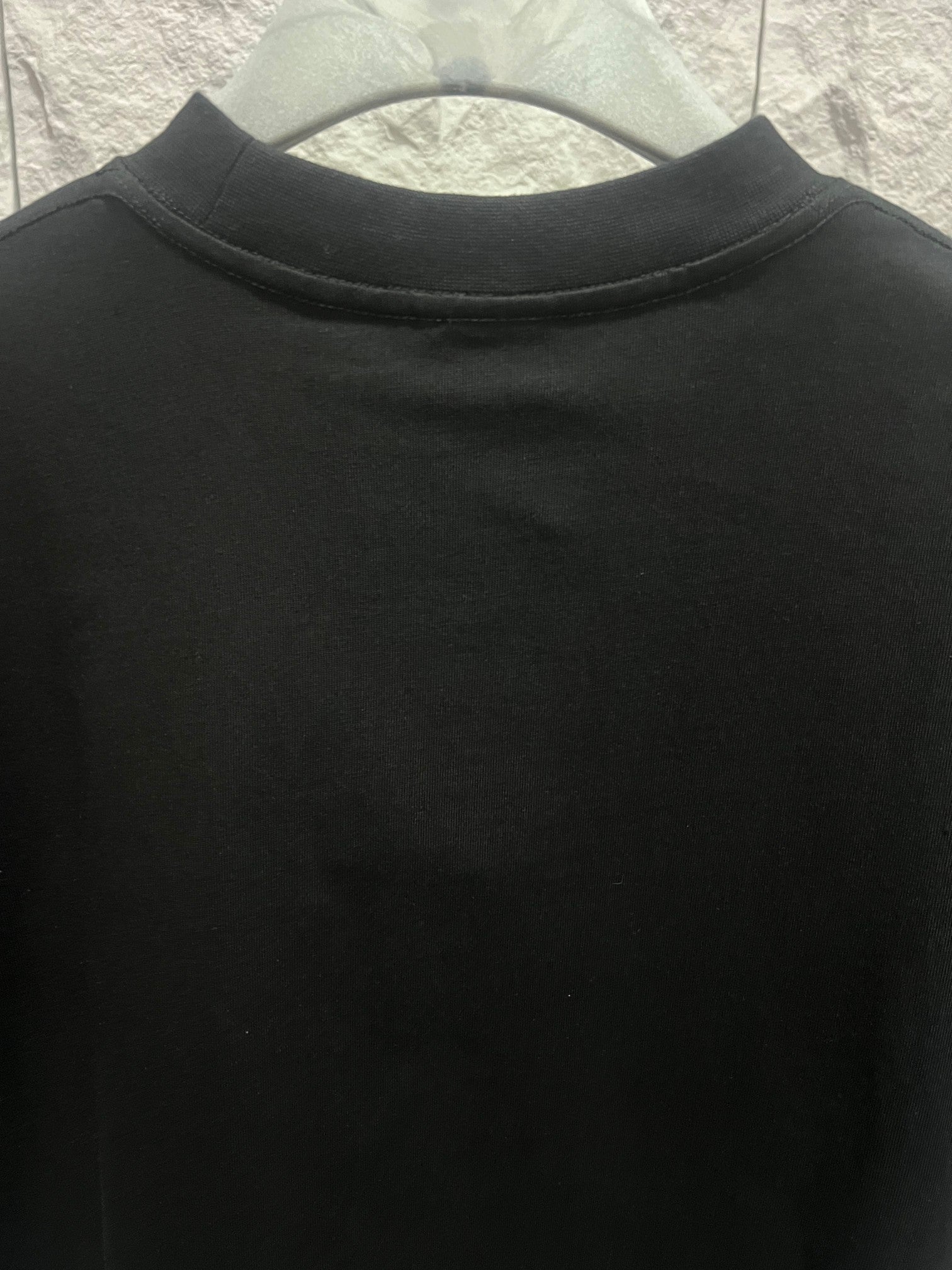 Black short-sleeve T-shirt with ribbed crew neck, no visible logo
