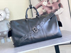 Louis Vuitton men's duffel bag with patterned monogram strap detail, dark blue leather