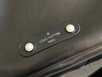Louis Vuitton men's duffel bag close-up of logo patch on dark leather strap