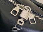 Louis Vuitton men's duffel bag close-up of zipper pulls with LV charms and logo labels