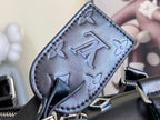 Louis Vuitton men's duffel bag close-up of embossed monogram pattern on dark leather