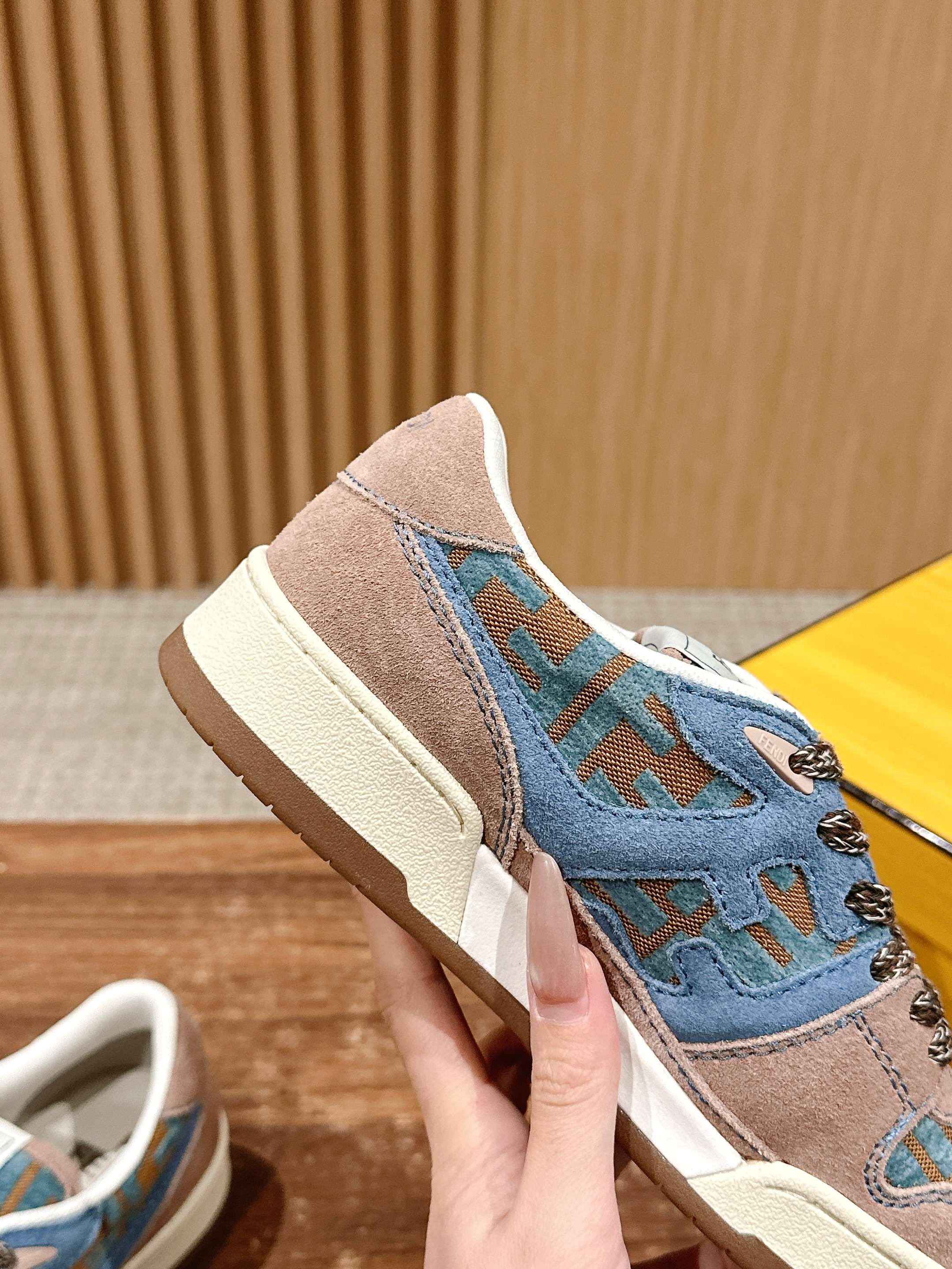 Fendi unisex side view sneakers with blue printed sections and tan heel
