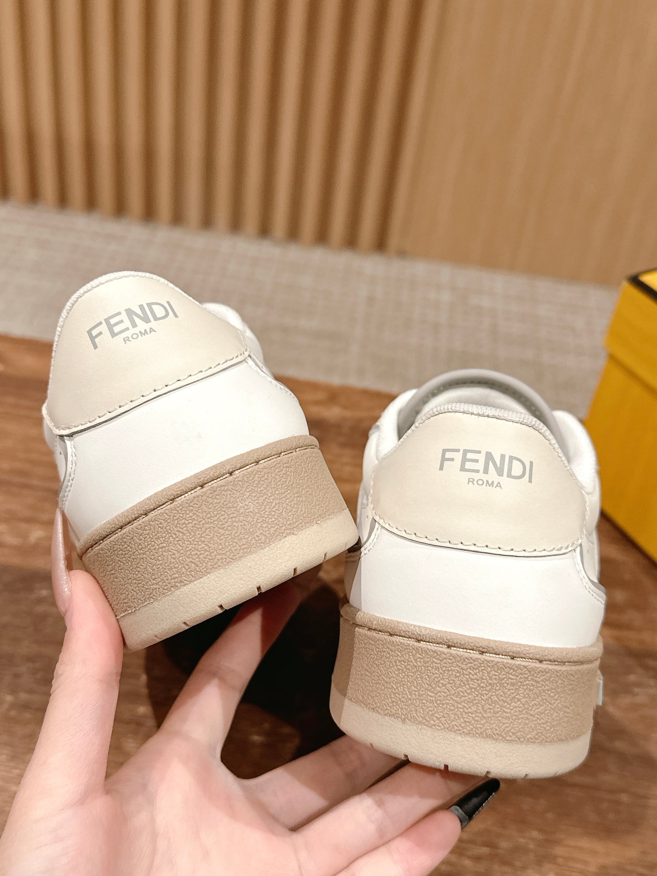 Cream white unisex sneakers from heel view, Fendi logo on back