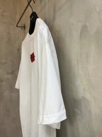 Balenciaga white T-shirt side view with red logo patch at chest