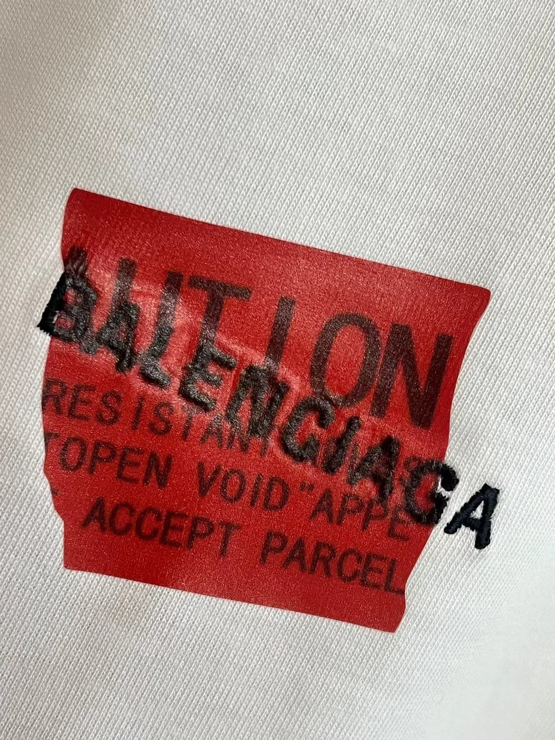 Balenciaga red rectangular logo patch on white T-shirt fabric