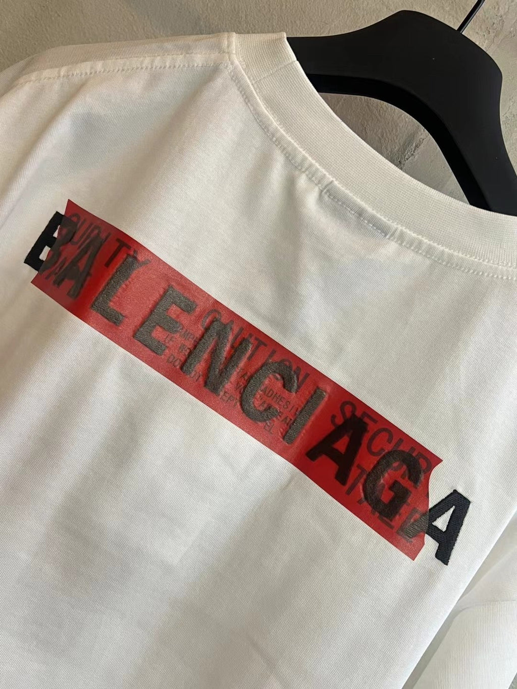 Balenciaga white T-shirt with red BALENCIAGA graphic across chest