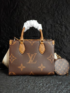 Brown monogram handbag with ribbon handles, front pockets, and round crossbody pouch