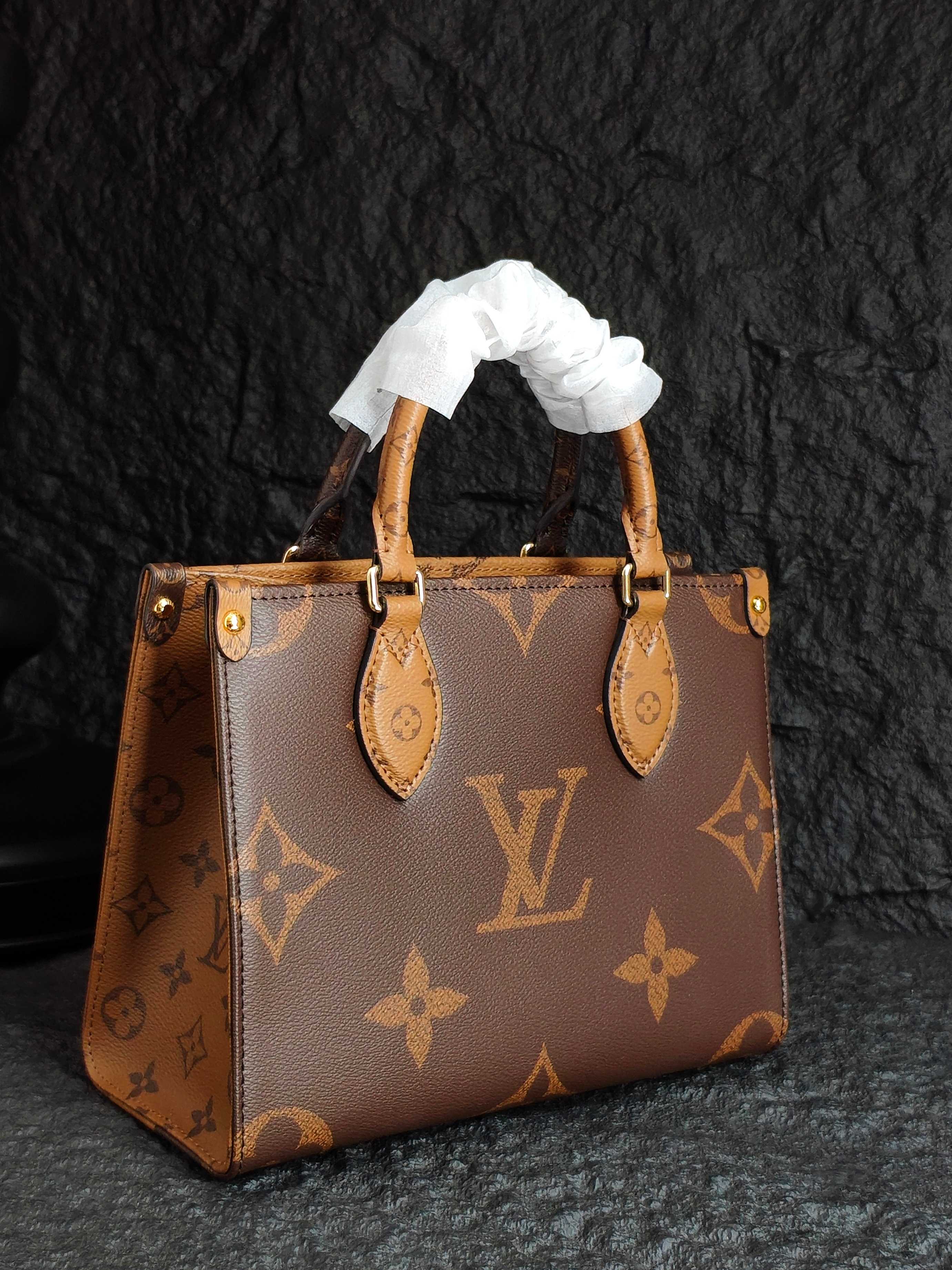 Brown monogram tote bag with ribbon top handles and gold-tone hardware