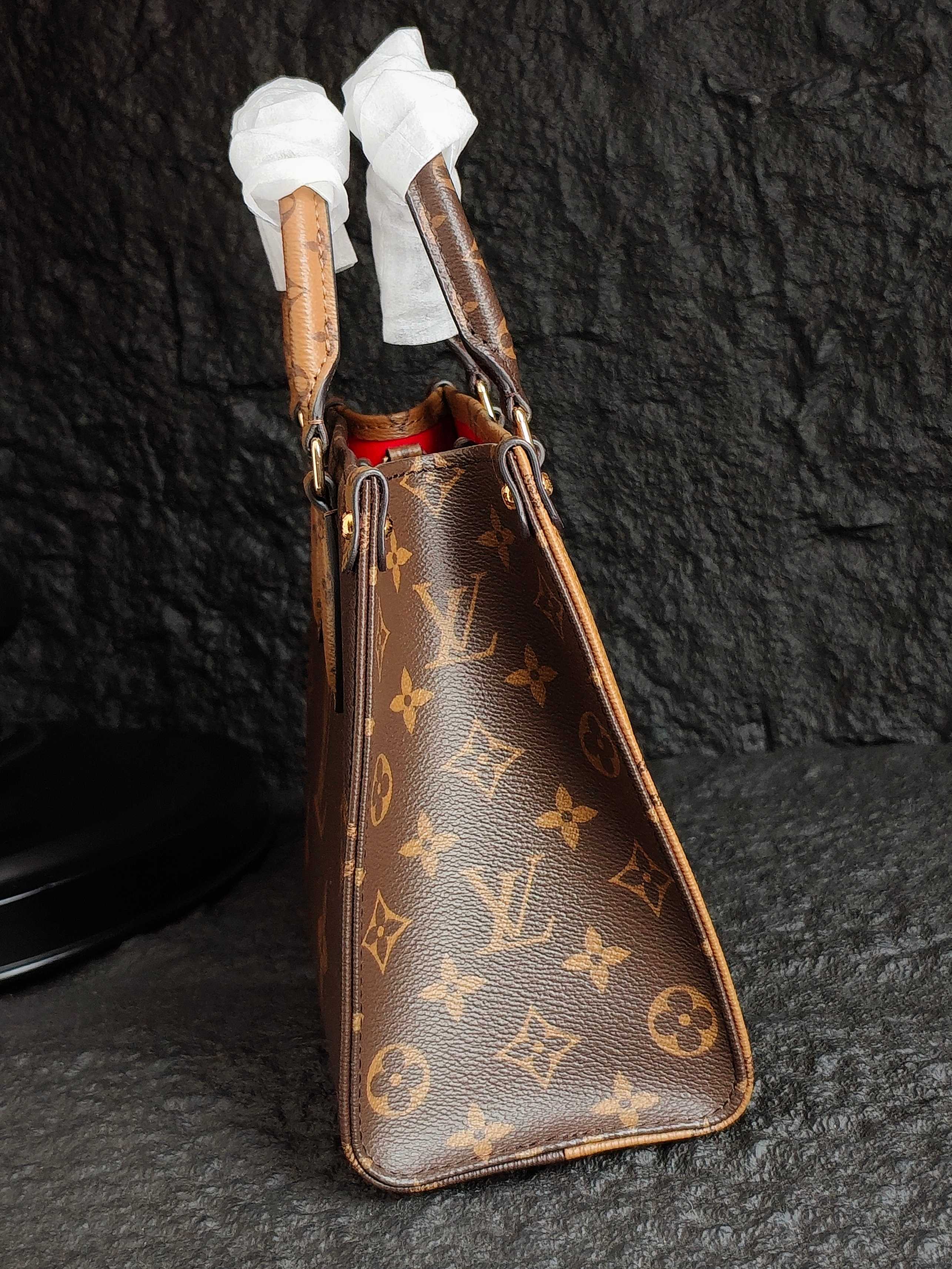Brown monogram shoulder bag with ribbon-wrapped handles and long strap