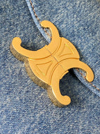 Gold-tone C logo embellishment on blue denim bag fabric