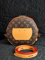 Monogram canvas crossbody bag with tan front flap pocket and gold hardware