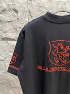 Balenciaga dark T-shirt back view with red shield crest and Balenciaga logos on sleeve