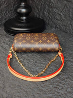 Louis Vuitton monogram shoulder bag with gold chain and orange-red piping