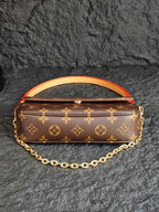 Louis Vuitton monogram bag with orange-red piping and gold chain strap