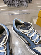 Fendi unisex sneakers, side close-up with adjustable strap, blue uppers, and lace eyelets