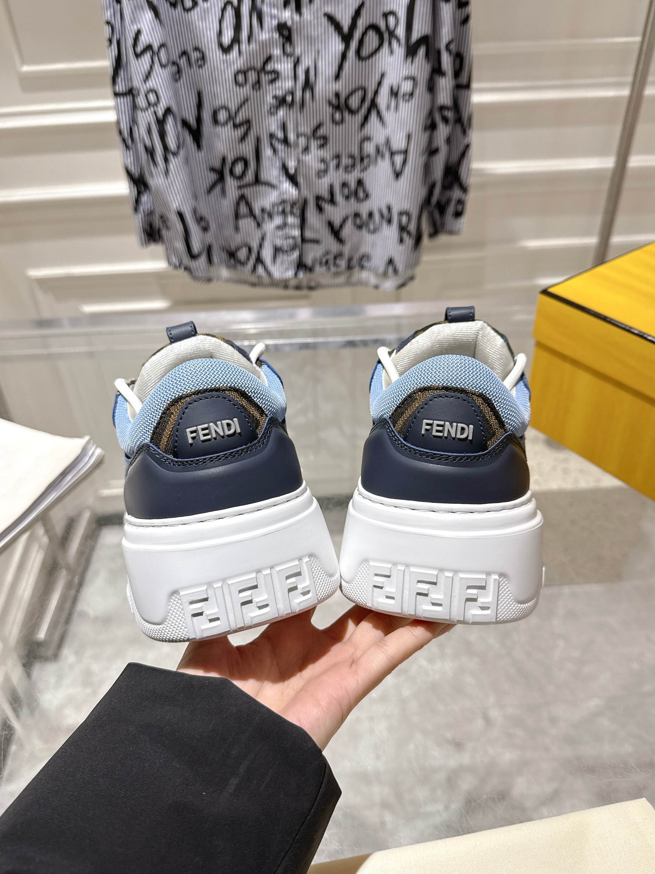 Fendi unisex sneakers, heel view with navy back panels, light-blue lining, and FENDI print