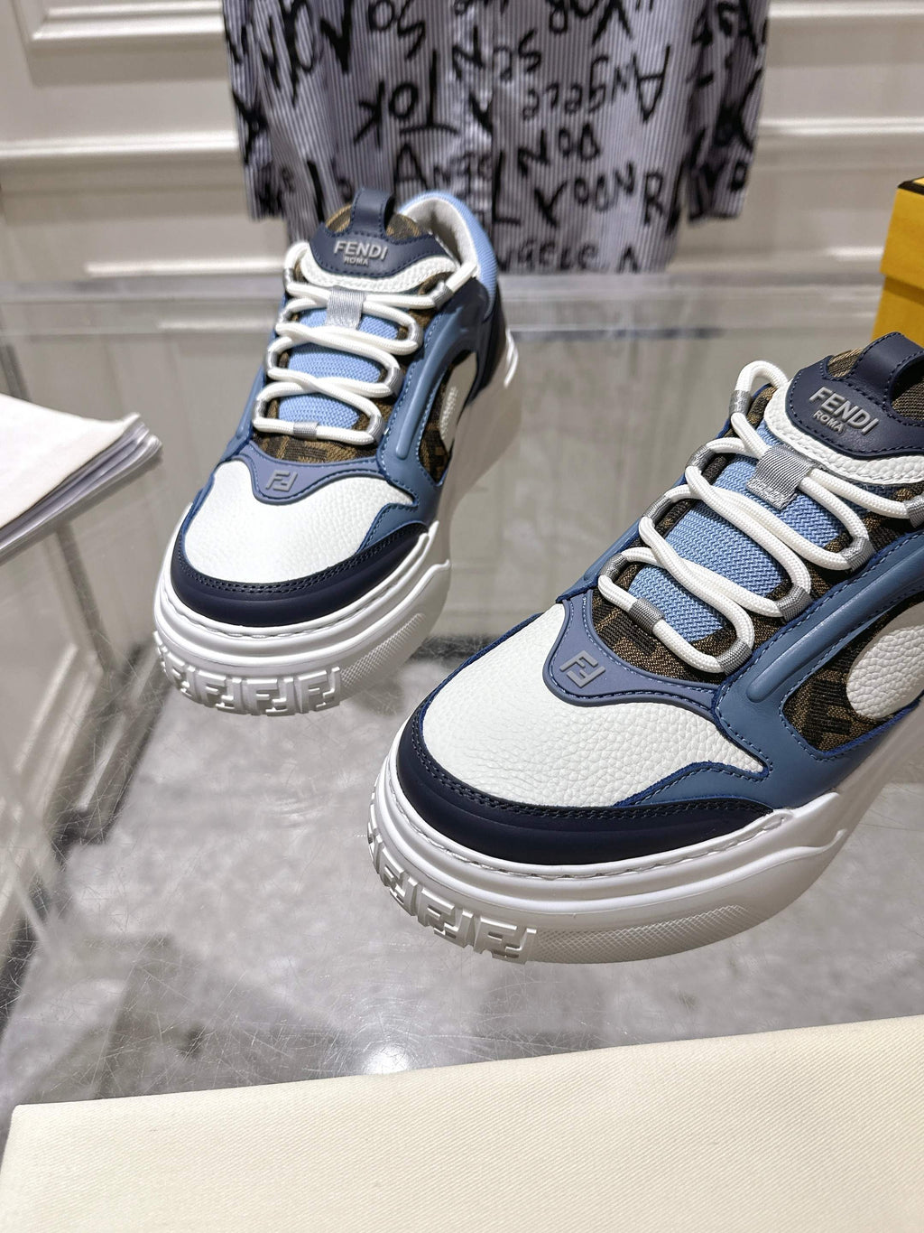 Fendi unisex sneakers, close view of lace-up front in navy, light-blue, and white