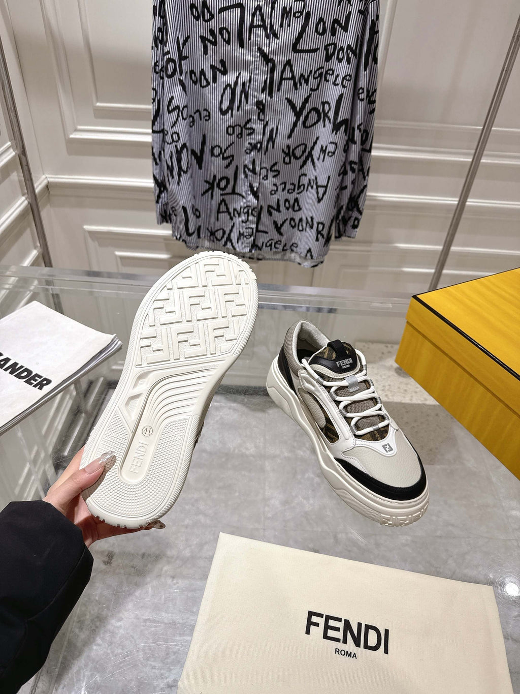 Fendi unisex sneakers, outsole view with tread and white upper with black accents