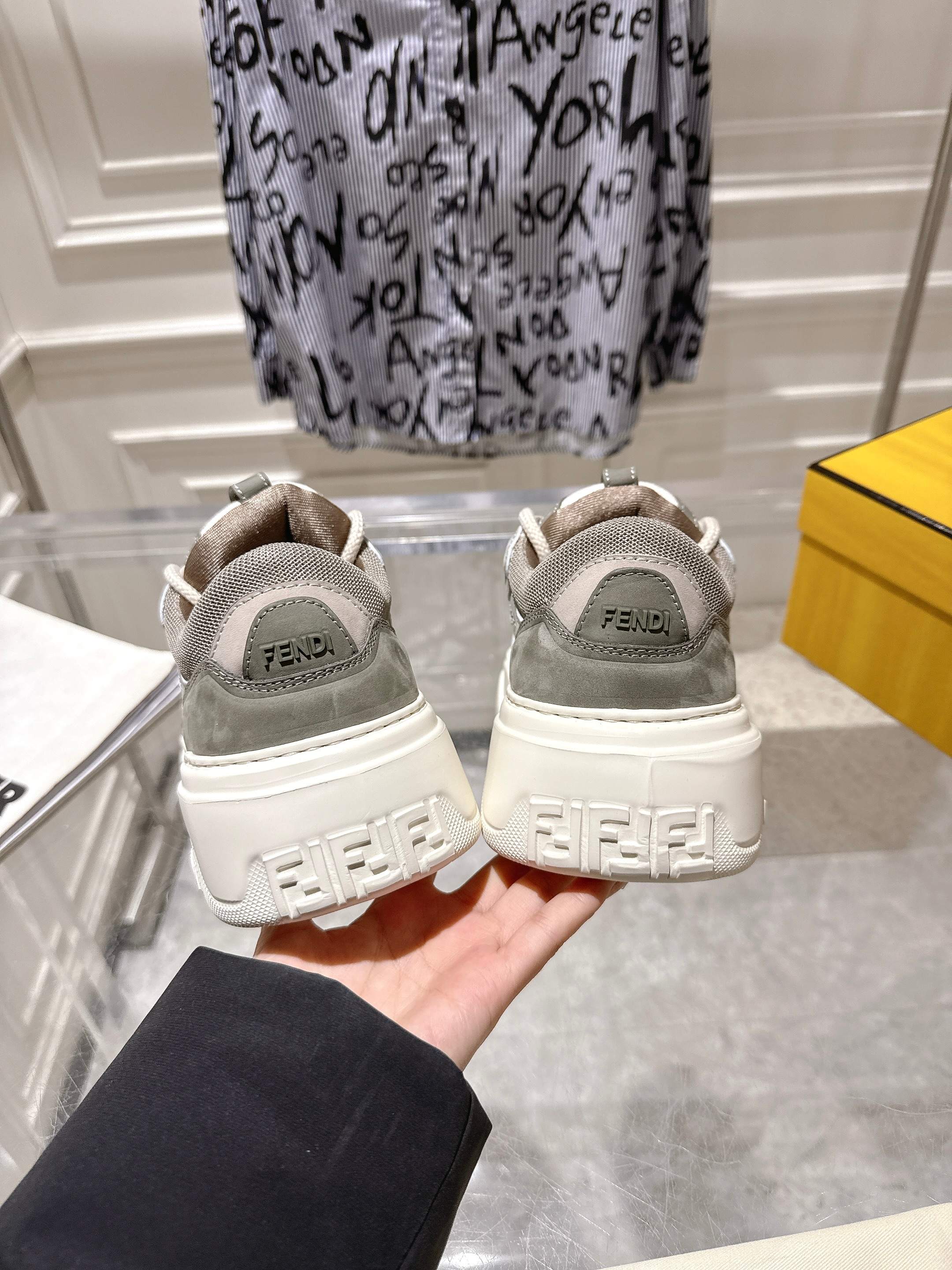Gray and white Fendi sneakers with back logos, heel view