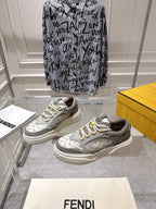 Gray and white Fendi sneakers with lace-up front, angled view