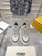 Gray and white unisex Fendi sneakers with lace-up front and yellow accents
