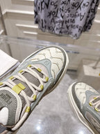 Close-up of gray Fendi sneaker toe with laces and textured logo patch