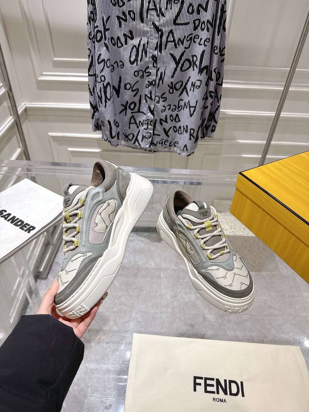 Gray and white lace-up Fendi sneakers, pair view with chunky sole