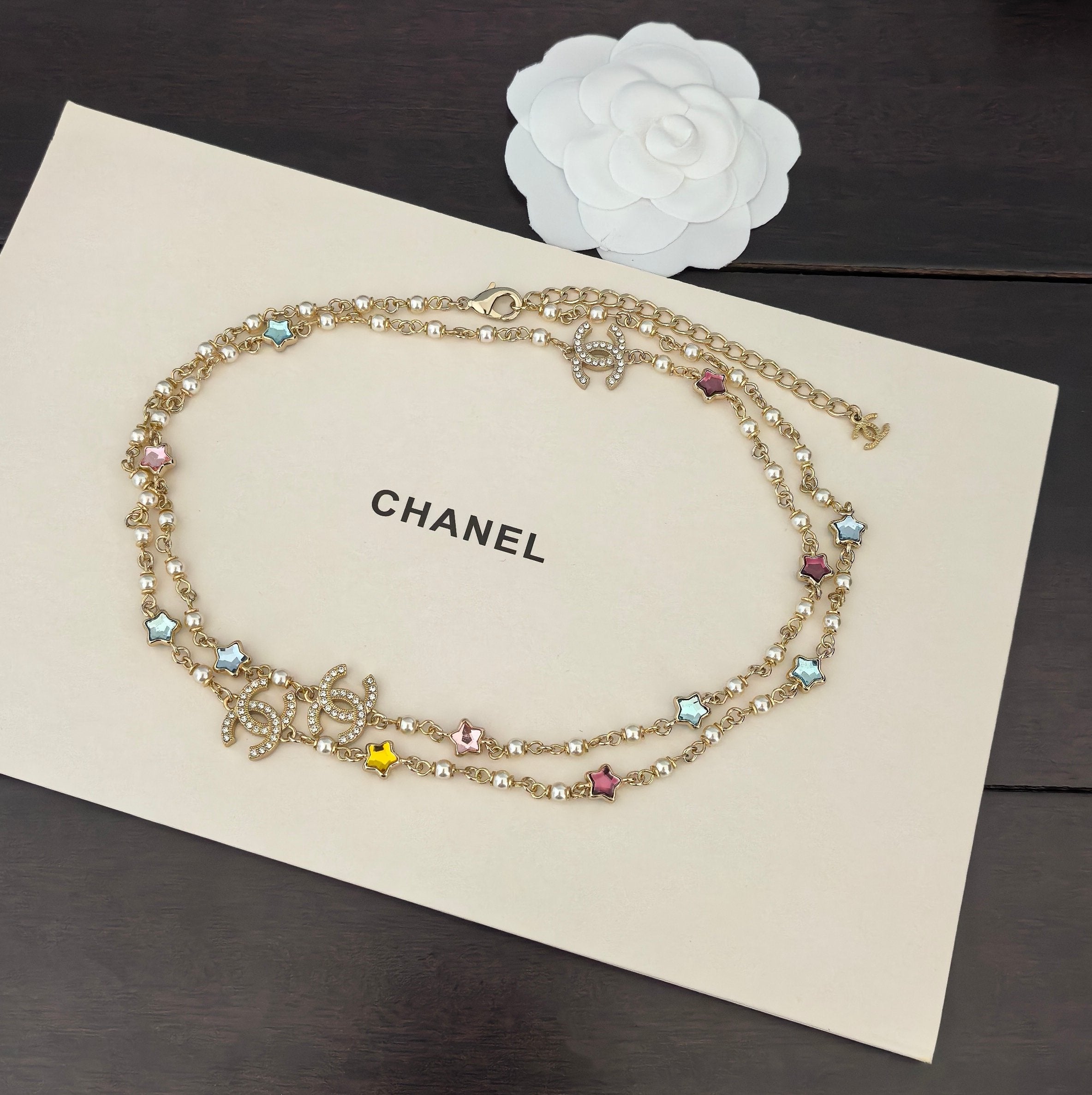 Gold-tone Chanel charm necklace with multicolor stone beads and small dangling motifs