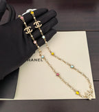 Gold-tone Chanel charm necklace with multicolor star and flower stones, double chain