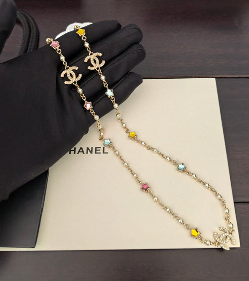 Gold-tone Chanel charm necklace with multicolor star and flower stones, double chain