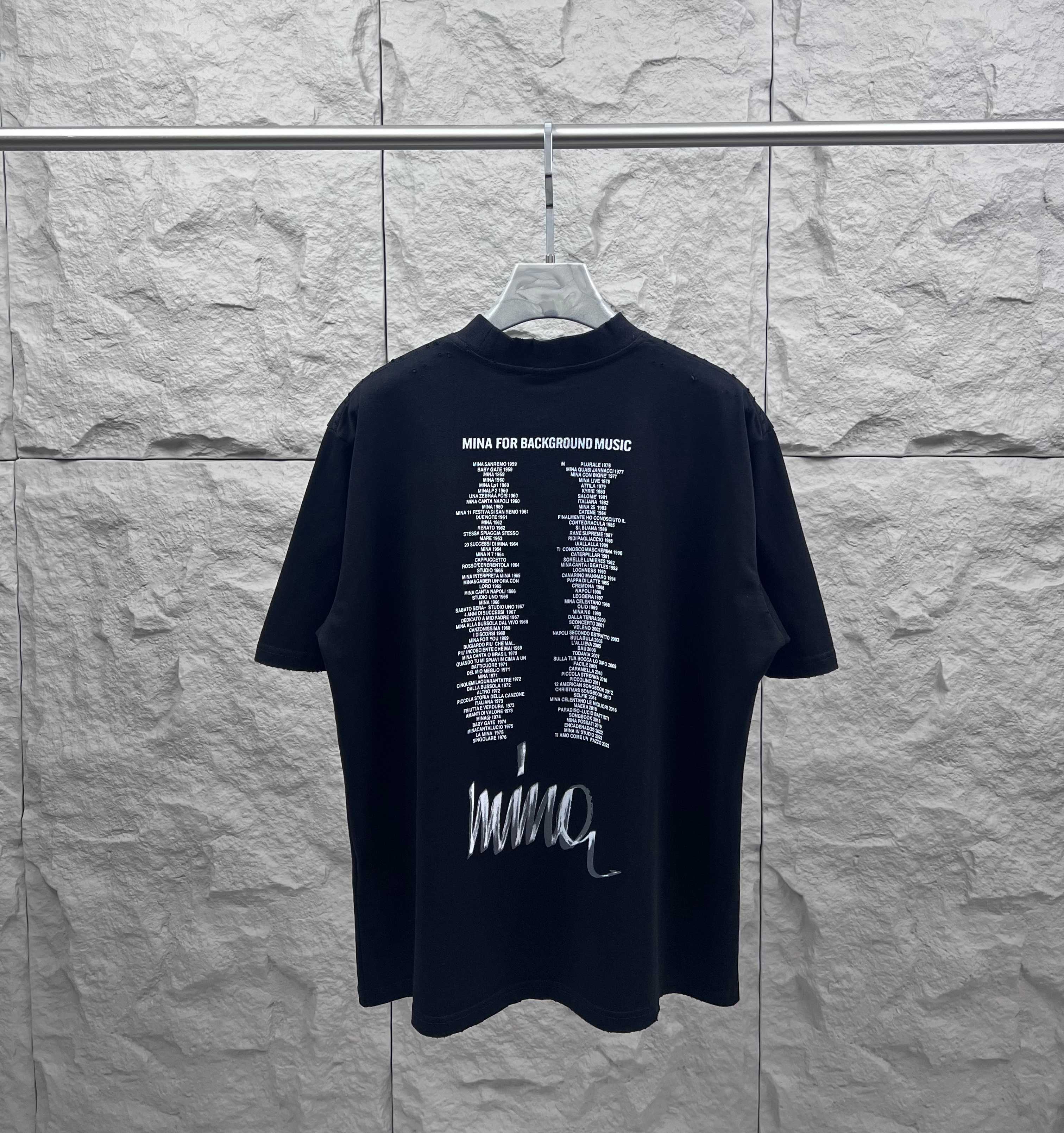 Balenciaga black T-shirt with printed text and white Mina logo on back