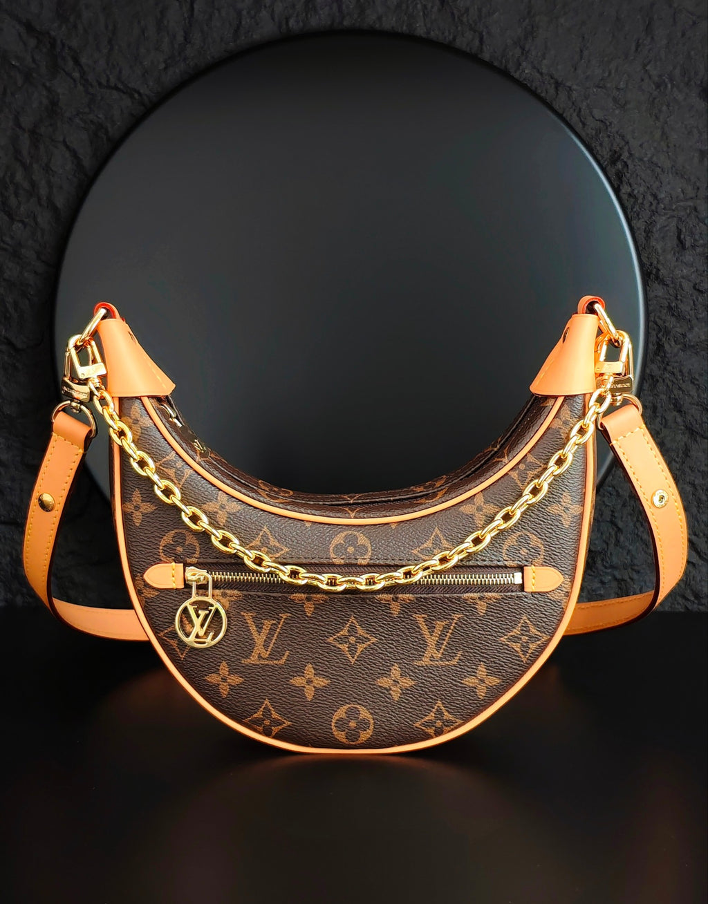 Louis Vuitton hobo bag with monogram canvas, gold chain strap, tan leather trim