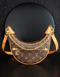 Louis Vuitton hobo bag with monogram canvas, gold chain strap, tan leather trim