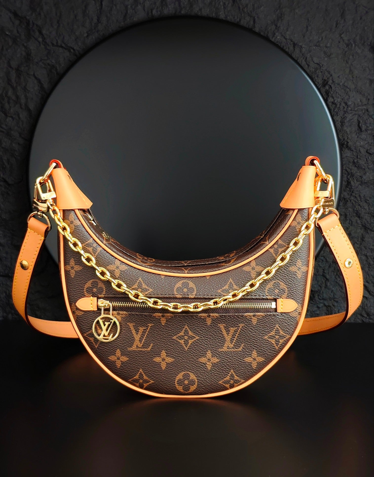 Louis Vuitton hobo bag with monogram canvas, gold chain strap, tan leather trim